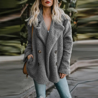 Stylish woman in a gray fur winter coat, combining warmth and elegance during the cold season. Perfect for winter fashion.